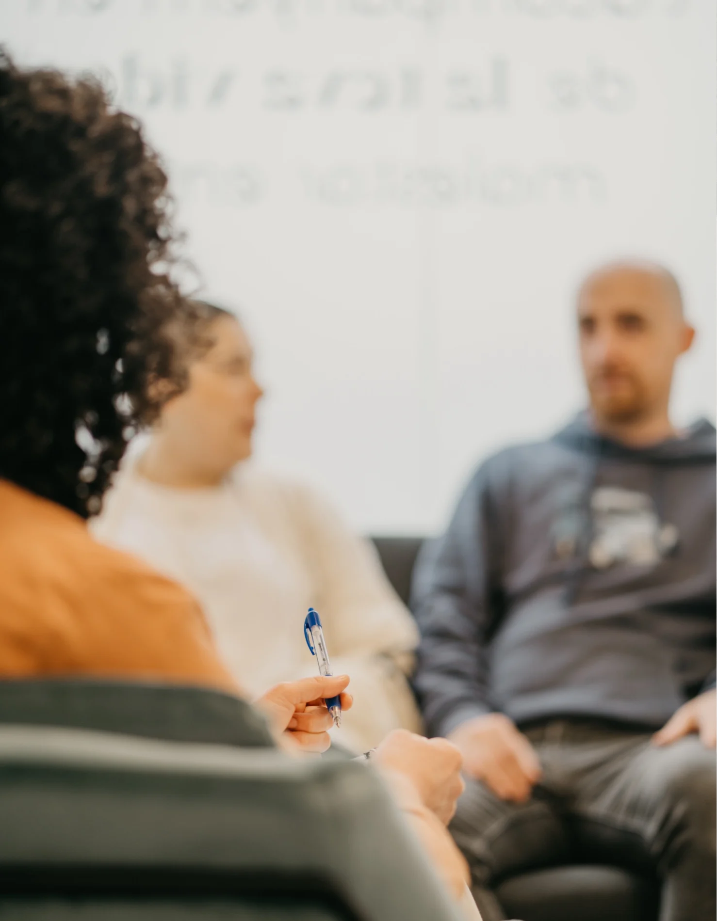 A couple talks with their therapist during a couples therapy session